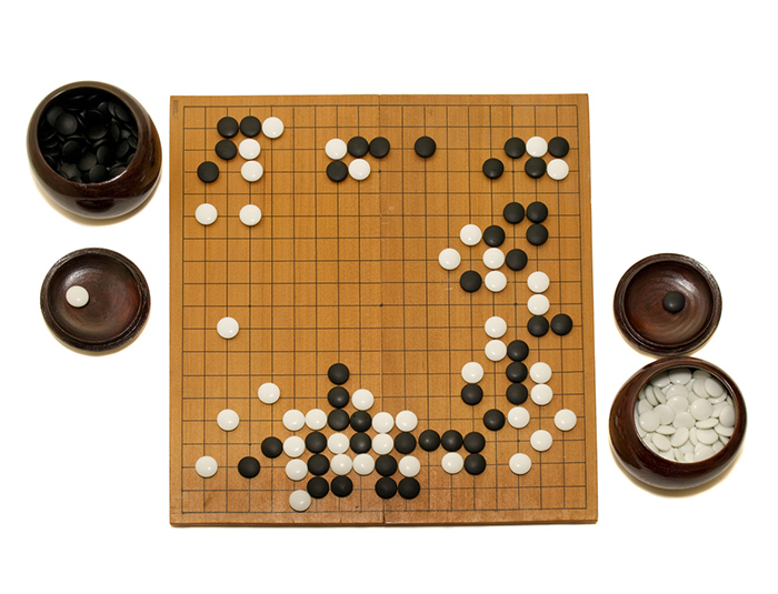 The game of Go, simple to learn but a lifetime to master for a human.