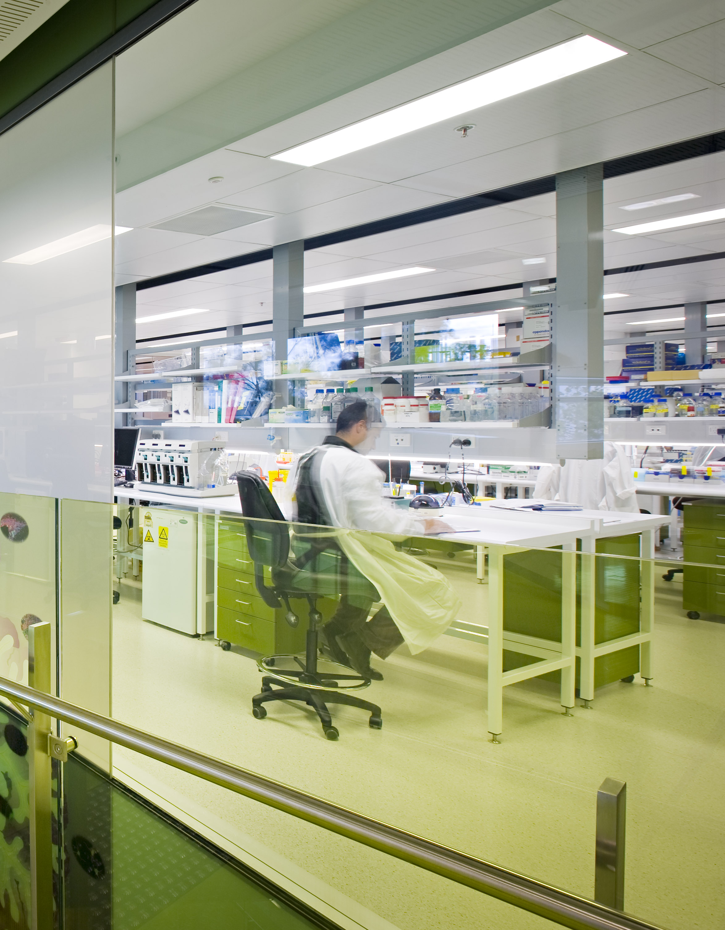 Researcher sitting at a bench, working in a research lab