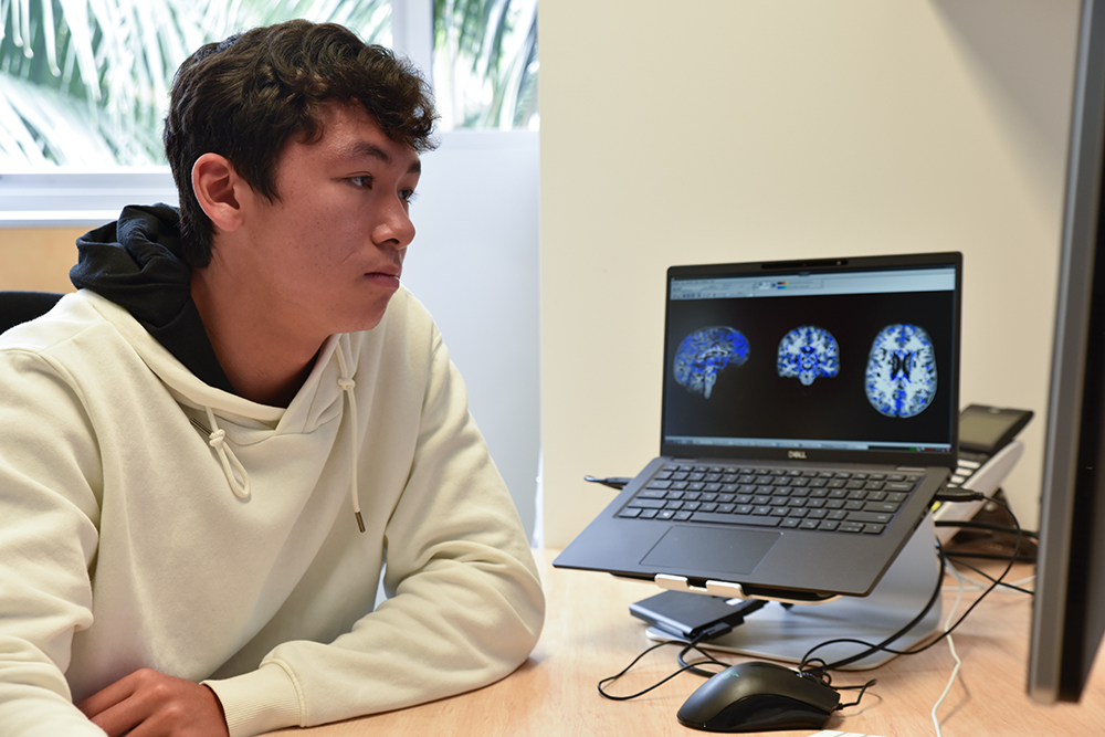 Year 10 student Marcus Paice studying brain scans at QBI.