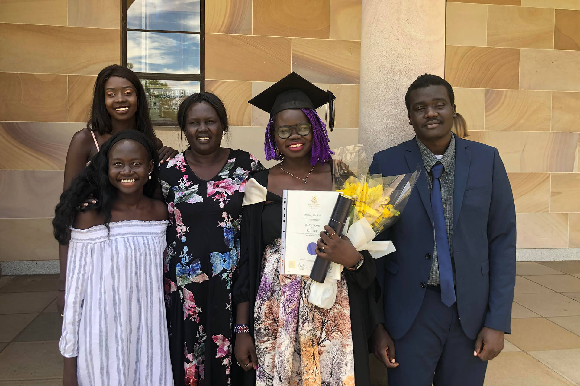 Nyakuoy and her family celebrate her graduation at The University of Queensland.