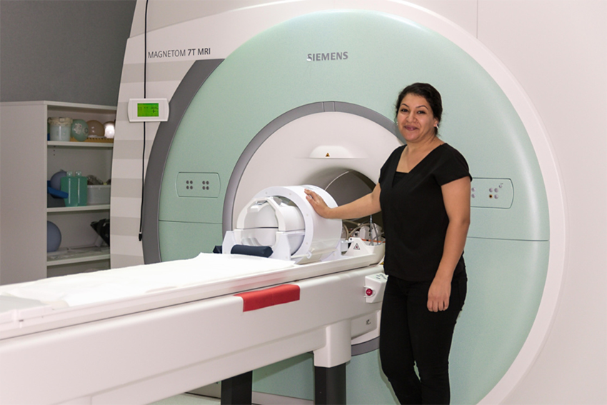 Associate Professor Nasrallah with the Magnetic Resonance Imaging (MRI) machine.