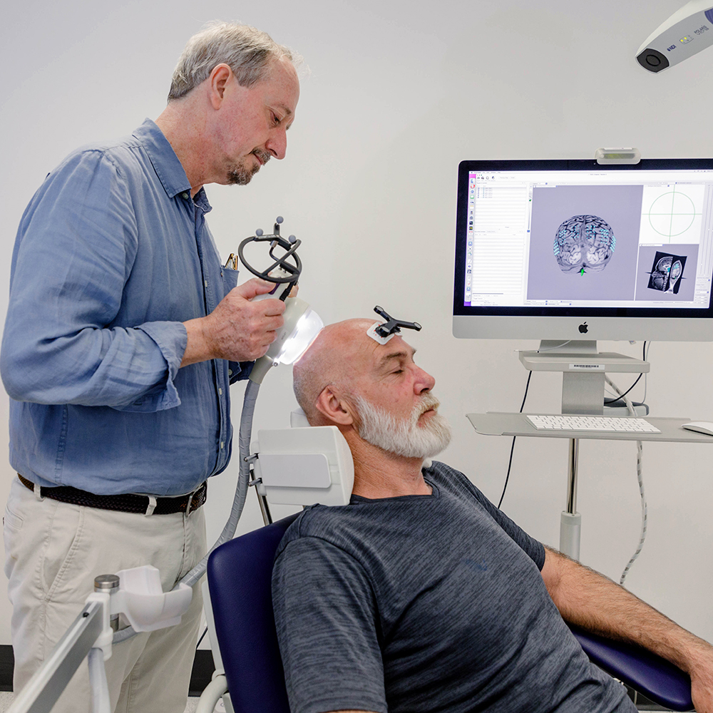 Professor Peter Silburn with the new device which has the potential to improve or restore cognitive function.