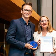 Dr Sean Coakley receiving his QLD Young Tall Poppy Award from Professor Jenny Martin AC.